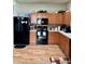 Nice kitchen with black appliances and wood cabinets at 14580 Wake Robin Dr, Brooksville, FL 34604