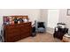 Bright bedroom with a dresser and comfy chair at 14580 Wake Robin Dr, Brooksville, FL 34604