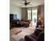 Relaxing living room with sliding doors to a patio, comfy seating and ceiling fan at 14580 Wake Robin Dr, Brooksville, FL 34604