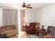 Comfortable living room with two recliners, a couch, and ceiling fan at 14580 Wake Robin Dr, Brooksville, FL 34604