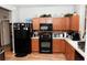 Nice kitchen with black appliances and wood cabinets at 14580 Wake Robin Dr, Brooksville, FL 34604