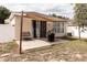 Relaxing backyard patio with shade awning and grill at 14580 Wake Robin Dr, Brooksville, FL 34604