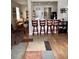 Open living area with hardwood floors, bar seating, and access to the kitchen at 14580 Wake Robin Dr, Brooksville, FL 34604