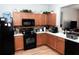 Nice kitchen with black appliances and wood cabinets at 14580 Wake Robin Dr, Brooksville, FL 34604