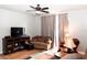 Cozy living room featuring a sectional sofa and a ceiling fan at 14580 Wake Robin Dr, Brooksville, FL 34604
