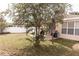 Spacious backyard with mature tree and patio at 14580 Wake Robin Dr, Brooksville, FL 34604