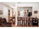 Open living area with hardwood floors, bar, and access to the kitchen at 14580 Wake Robin Dr, Brooksville, FL 34604