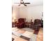 Spacious living room with two recliners, end tables, and a ceiling fan at 14580 Wake Robin Dr, Brooksville, FL 34604