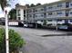 Covered parking area with designated parking spots at 1375 Doolittle Ln # 201, Dunedin, FL 34698