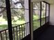 Screened balcony overlooking a lush green landscape at 1375 Doolittle Ln # 201, Dunedin, FL 34698