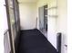 Screened lanai with dark flooring and sliding glass door at 1375 Doolittle Ln # 201, Dunedin, FL 34698