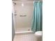 Clean bathroom with shower and teal shower curtain at 1375 Doolittle Ln # 201, Dunedin, FL 34698