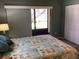 Main bedroom with sliding glass doors to balcony at 1375 Doolittle Ln # 201, Dunedin, FL 34698