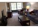 Living room with balcony access and relaxing seating at 1375 Doolittle Ln # 201, Dunedin, FL 34698