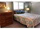 Bedroom with dresser and bed featuring coastal bedding at 1375 Doolittle Ln # 201, Dunedin, FL 34698