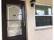 Exterior view of condo entryway with black door and window at 1375 Doolittle Ln # 201, Dunedin, FL 34698