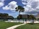 Community pool with surrounding patio furniture at 1375 Doolittle Ln # 201, Dunedin, FL 34698