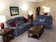 Living room featuring comfortable reclining furniture at 1375 Doolittle Ln # 201, Dunedin, FL 34698