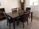 Dining area with a dark wood table and four chairs at 1375 Doolittle Ln # 201, Dunedin, FL 34698