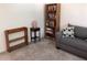 Cozy living room featuring a sofa, bookcase, and end table at 1375 Doolittle Ln # 201, Dunedin, FL 34698