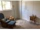 Bedroom with rocking chair, ottoman, and small table at 1375 Doolittle Ln # 201, Dunedin, FL 34698