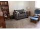 Living room with love seat, rocking chair, and bookcase at 1375 Doolittle Ln # 201, Dunedin, FL 34698