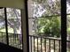 View of lush green landscape from screened balcony at 1375 Doolittle Ln # 201, Dunedin, FL 34698