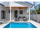 Covered back patio with seating area overlooking a sparkling pool at 316 11Th N Ave, St Petersburg, FL 33701