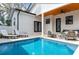 Relaxing backyard featuring a pool, a jacuzzi, an outdoor seating area with ceiling fan, and manicured landscaping at 316 11Th N Ave, St Petersburg, FL 33701