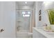 Bright bathroom with a tub-shower combo and double sink vanity featuring marble countertops at 316 11Th N Ave, St Petersburg, FL 33701