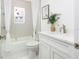 Bright bathroom features a shower-tub combo with tiled surround and white vanity with stone countertop at 316 11Th N Ave, St Petersburg, FL 33701
