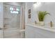 Bright bathroom with double sinks, marble-style countertops, modern fixtures, and a combined tub and shower at 316 11Th N Ave, St Petersburg, FL 33701