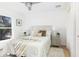 Bright bedroom boasts a ceiling fan, natural light from the window and neutral decor at 316 11Th N Ave, St Petersburg, FL 33701