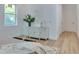 Bedroom features light wood floors and a stylish white cabinet beneath artwork next to a window at 316 11Th N Ave, St Petersburg, FL 33701