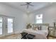 Cozy bedroom with a ceiling fan and light wood floors, furnished with comfortable seating and elegant décor at 316 11Th N Ave, St Petersburg, FL 33701