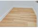 Close-up of light, newly installed wood flooring with crisp white trim in a modern space at 316 11Th N Ave, St Petersburg, FL 33701