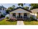 Charming single-story home featuring a well-manicured lawn and inviting front porch with seating area at 316 11Th N Ave, St Petersburg, FL 33701