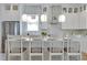 A stylish kitchen with white cabinets, marble countertops, designer backsplash, and pendant lighting at 316 11Th N Ave, St Petersburg, FL 33701