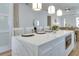 Modern kitchen island with white countertops, ample seating, built-in microwave, and pendant lighting at 316 11Th N Ave, St Petersburg, FL 33701