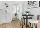 Bright kitchen features white cabinets, subway tile backsplash, stainless steel faucet and a dining table set with white chairs at 316 11Th N Ave, St Petersburg, FL 33701