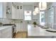 Modern kitchen with stainless steel appliances and bright white marble countertops and backsplash at 316 11Th N Ave, St Petersburg, FL 33701