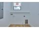 Simple laundry room, awaiting appliances, with a large window and light hardwood floor at 316 11Th N Ave, St Petersburg, FL 33701