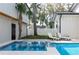 Backyard pool with a jacuzzi, lounge chairs, and lush greenery create a private oasis perfect for relaxation at 316 11Th N Ave, St Petersburg, FL 33701