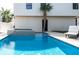 Beautiful pool with a jacuzzi, a palm tree, and a comfortable lounge chair next to the pristine blue water at 316 11Th N Ave, St Petersburg, FL 33701