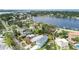 A tranquil neighborhood showcasing a lake with a blue home, with lush green trees and blue skies at 4234 4Th S St, St Petersburg, FL 33705