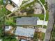 Overhead view of home featuring a new roof, green grass, and an adjacent grey rooftop at 4234 4Th S St, St Petersburg, FL 33705