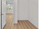 Bright bedroom with wood-look flooring and doorway leading into another room at 4234 4Th S St, St Petersburg, FL 33705