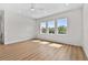 Spacious bedroom featuring hardwood floors, a ceiling fan, recessed lights, and an abundance of natural light at 4234 4Th S St, St Petersburg, FL 33705