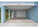Spacious carport featuring modern garage door, recessed lighting, and a well-maintained concrete floor at 4234 4Th S St, St Petersburg, FL 33705