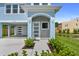 Home with front door, modern lighting, freshly landscaped yard, and covered carport at 4234 4Th S St, St Petersburg, FL 33705